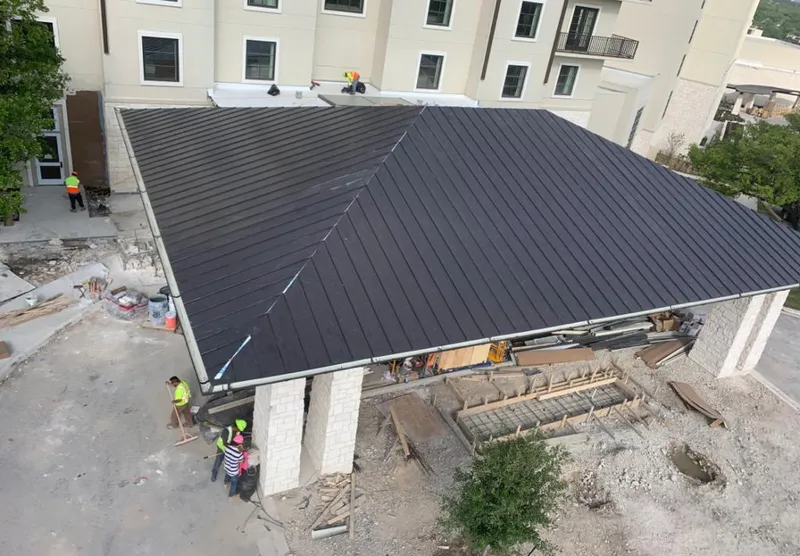 Metal roofing installation team working on a commercial building in Bainbridge